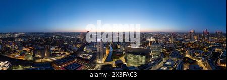 A breathtaking panoramic cityscape captured during the golden hour, showcasing the city's vast expanse and the transition from day to night Stock Photo