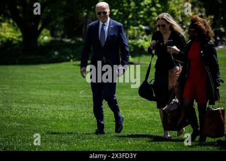 Washington, United States. 26th Apr, 2024. President Joe Biden walks across the South Lawn with White House Press Secretary Karine Jean-Pierre (right) and eputy Chief of Staff Annie Tomasini (center) towards the White House on April 26, 2024 in Washington, DC. President Biden said that he's willing to debate former President Donald Trump, who is the presumptive Republican Presidential nominee, during an interview with Howard Stern this morning. (Photo by Samuel Corum/Sipa USA) Credit: Sipa USA/Alamy Live News Stock Photo