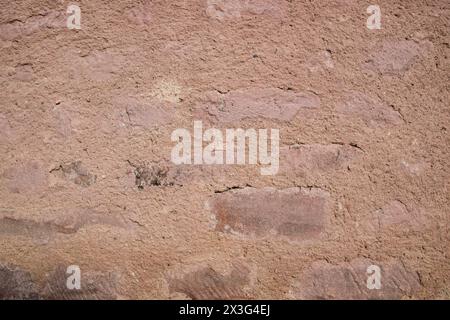 Gray structural stone wall of old building consists of broken bricks. Nature structural background. Stock Photo