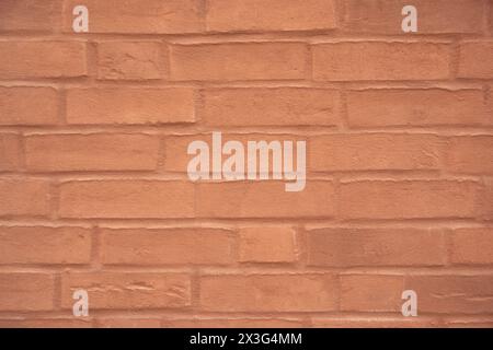 Red structural stone wall of the ancient building consists of old bricks. Nature structural background. Stock Photo