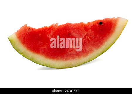 Red ripe watermelon with green rind cut into different sized pieces with black seeds on white background. Professional studio macro photography Stock Photo