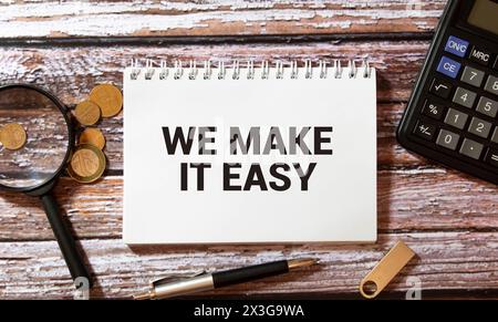 WE MAKE IT EASY! message on the card shown by a man, vintage tone. Stock Photo