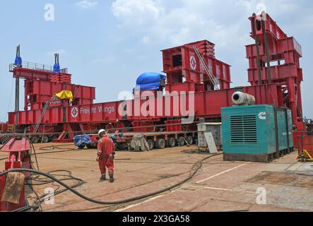 Mumbai, Maharashtra, India. 26th Apr, 2024. A construction worker is seen working on a barge vessel opposite the bow string arch bridge (not in picture) connecting coastal road to Bandra Worli sealink installed at the Worli (area in South Mumbai) end in Mumbai. (Credit Image: © Ashish Vaishnav/SOPA Images via ZUMA Press Wire) EDITORIAL USAGE ONLY! Not for Commercial USAGE! Credit: ZUMA Press, Inc./Alamy Live News Stock Photo