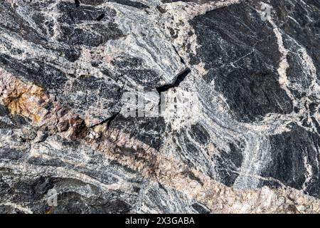 Full frame abstract texture background of the textured surface on a large striated granite rock Stock Photo