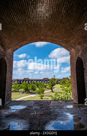 View through an open archway in Fort Jefferson on Dry Tortugas National Park with a the open courtyard a parade ground in the distance. Stock Photo