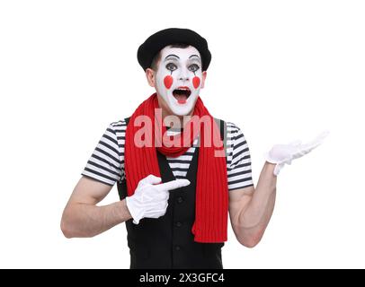 Mime artist making shocked face and pointing at something on white background Stock Photo