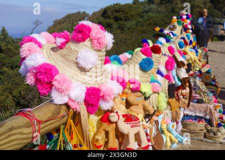 Tangier, Morocco. February 6, 2024 - Souvenir hats and toys for sale at a seaside viewpoint. Stock Photo