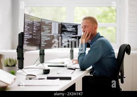 Coder Using Computer At Desk. Web Developer Stock Photo