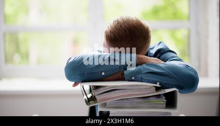 Young Businessman At Desk Doing Accounting In Office Stock Photo