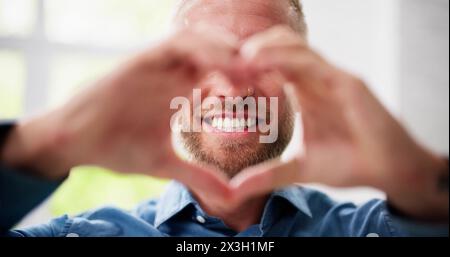 Man Making Heart Sign. Senior Hands Romantic Love Stock Photo