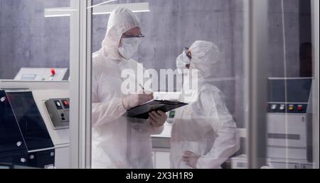 Clean engineer working in factory laboratory with tablet. Stock Photo
