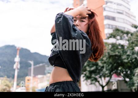 Expressive Korean dancer striking a pose on an urban street, showcasing a mix of serenity and motion Stock Photo