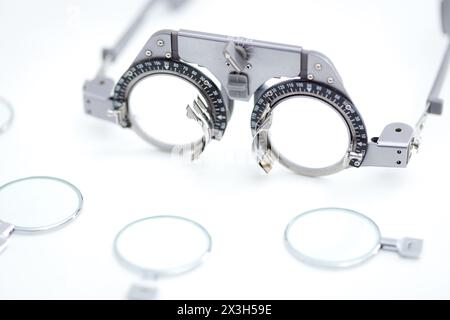 Close up of Eye test frame for optician with many different trial lenses for eye protect over white background Stock Photo