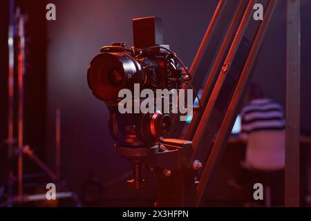 Closeup background image of digital video camera set up on rig in studio with neon lights copy space Stock Photo