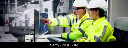 Man and engineer operating SCADA system with AI-driven machine Stock Photo