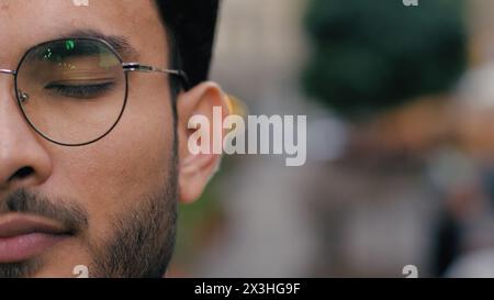 Close up young confident professional Indian Arabian ethnic guy male student model businessman man's face eye glasses eyewear looking at camera Stock Photo