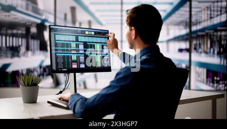 Spreadsheet Analyst Employee Using Computer Monitors For Analysis Stock Photo