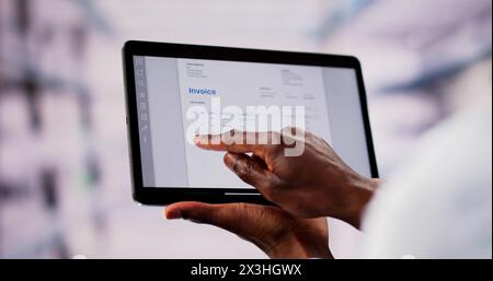 Accountant Checking Online Invoice On Tablet Screen Stock Photo