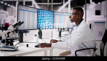 African American Analyzing Spreadsheet Data At Work Stock Photo