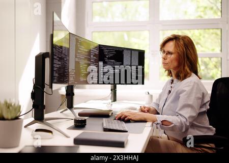 Software Programmer Or Coder Woman Using Office Computer Stock Photo