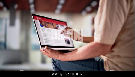 Watching News On Laptop Computer Screen Online At Home Stock Photo