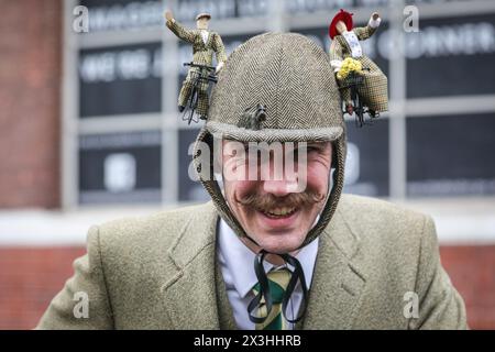 London, UK, 27th April 2024. A gentlemen with two waving cyclist figurines on his hat. Participants at the early morning start. The Tweed Run is a bicycle ride through London’s historic streets, with a prerequisite that participants wear their best tweed and stylish cycling attire. It is organised by Bourne & Hollingsworth, started in 2008 with just a small group of friends sees around 800 cyclists riding through central London. Copyright: Imageplotter/Alamy Live News Stock Photo