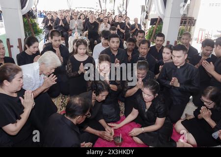 Phatthalung, Thailand- April 05, 2024: People and relatives wear black and pray before the coffin of the deceased at the cremation ceremony Stock Photo