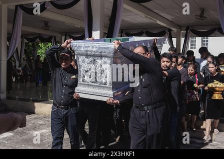 Phatthalung, Thailand- April 05, 2024: Man in black is helping to carry the coffin of the deceased into the crematorium for cremation Stock Photo