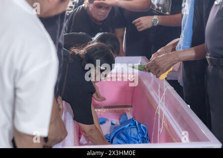 Phatthalung, Thailand- April 05, 2024: Relatives are organizing the ceremony and mourning over the body of the deceased Stock Photo