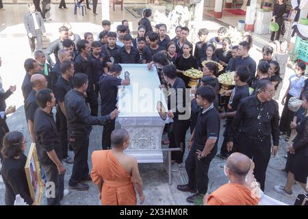 Phatthalung, Thailand- April 05, 2024: Undertaker is opening the coffin of a dead person to give relatives one last look before putting it in the crem Stock Photo