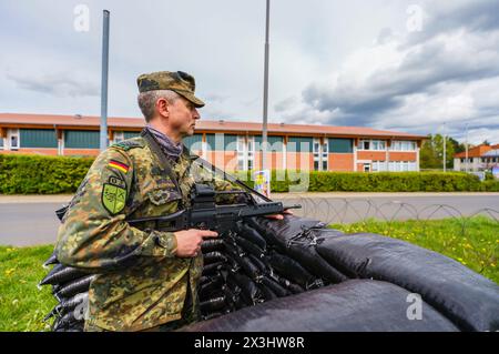 27 April 2024, Hesse, Alsfeld: Bundeswehr soldiers sit in an armored ...