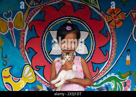 Chapainawabganj, Bangladesh. 27th Apr, 2024. A girl with her cat 