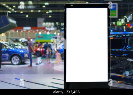 Digital signage mockup featuring a blank screen in a sleek car showroom. This versatile display promises dynamic advertising opportunities Stock Photo