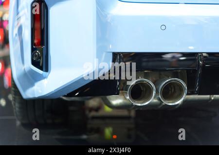 dynamic energy of a sport car's exhaust pipe. This close-up shot captures the intense power and performance of the vehicle, highlighting its sleek des Stock Photo