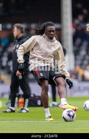 Calvin Bassey of Fulham warms up ahead of the Premier League match between Fulham and Crystal Palace at Craven Cottage, London, England on 27 April 2024. Photo by Grant Winter. Editorial use only, license required for commercial use. No use in betting, games or a single club/league/player publications. Credit: UK Sports Pics Ltd/Alamy Live News Stock Photo