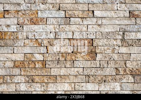 Background from a wall of beige and brown clinker bricks Stock Photo