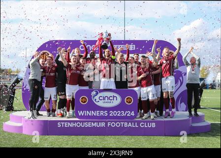 Stenhousemuir FC captain, Gregor Buchanan lifts the Cinch League Two trophy as his team celebrate their first ecer league win in their 140 year history. Stenhousemuir, Scotlaand, United Kingdom, 27/04/2024. Credit: Thomas Gorman/Alamy Live News Stock Photo