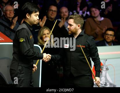 Jak Jones is congratulated by Si Jiahui on day eight of the 2024 Cazoo World Snooker Championship at the Crucible Theatre, Sheffield. Picture date: Saturday April 27, 2024. Stock Photo