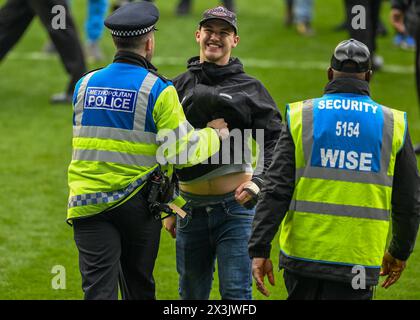 Millwall fans pitch invasion at full time during the Sky Bet Championship match Millwall vs Plymouth Argyle at The Den, London, United Kingdom, 27th April 2024 (Photo by Stan Kasala/News Images) in, on 4/27/2024. (Photo by Stan Kasala/News Images/Sipa USA) Credit: Sipa USA/Alamy Live News Stock Photo