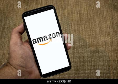 Sao Paulo, Brazil, April 16, 2024. Amazon logo is seen on a smartphone over straw background in Brazil Stock Photo