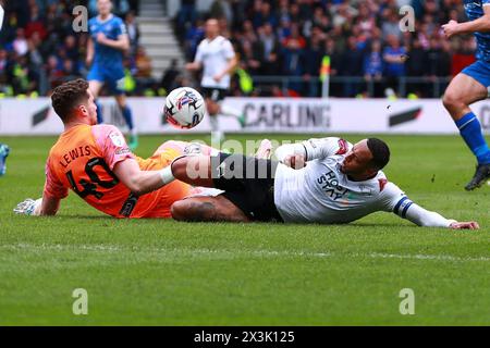 Derby, UK. 27th Apr, 2024. Nathaniel Mendez-Laing of Derby County and Harry Lewis of Carlisle United go for the ball during the Derby County FC v Carlisle United FC sky bet EFL League 1 match at Pride Park Stadium, Derby, England, United Kingdom on 27 April 2024 Credit: Every Second Media/Alamy Live News Stock Photo