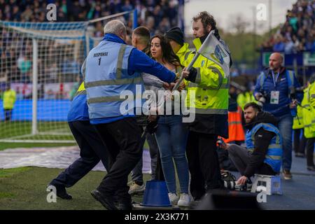 Sheffield, UK. 27th Apr, 2024. Pitch Invader carrying corner flag escorted off the pitch during the Sheffield Wednesday FC v West Bromwich Albion FC sky bet EFL Championship match at Hillsborough Stadium, Sheffield, England, United Kingdom on 27 April 2024 Credit: Every Second Media/Alamy Live News Stock Photo