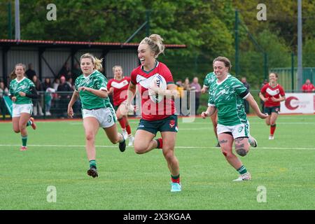 Bethan Dainton (Wales) breaks clear to score her second try during Wales rughy league's 28 - 10 defeat of Ireland. World Cup Qualifier,  27 Apr 2024, Cardiff.  Credit Alamy Live News/Penallta Photographis Stock Photo