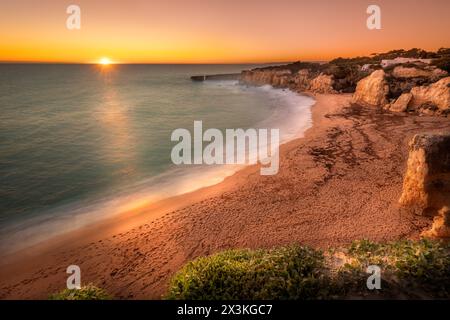 Sunset on the algarve beach of Praia do Castelo near Albufeira, Portugal with it's sandstone cliffs Stock Photo