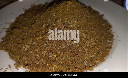 Ground carob pieces with their seeds Stock Photo