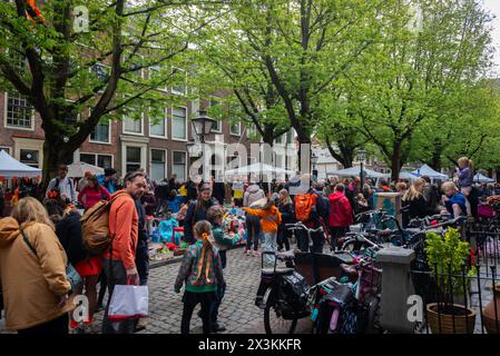 April 27, 2024, Leiden, Netherlands,  A busy day in the city center of the city during King's day. People are buying things kids toys and muffins. Stock Photo