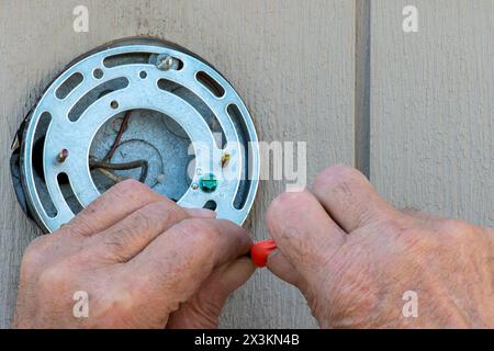 Hands of an Older man doing electrical work Stock Photo