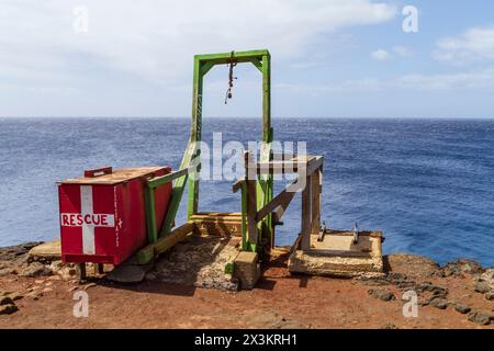 Old wooden boat hoist and first aid box at Ka Lae (South Point) near Naalehu, Hawaii, popular but dangerous spot for cliff diving. Stock Photo