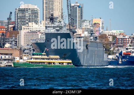 Sydney ferry passes Garden island naval base of the Royal Australian Navy, Potts Point apartment towers behind,Sydney,NSW,Australia Stock Photo