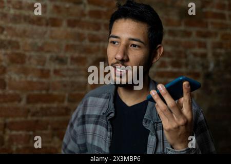 Latin American young man (24) talking on his cell phone. Concept of technology Stock Photo